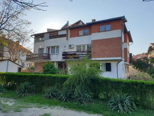 a house with a hedge in front of it at SMS Studios in Soko Banja