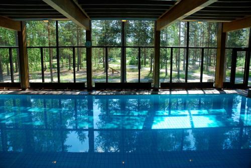 a swimming pool with a view of the trees at Hotel Kiljava in Kiljava