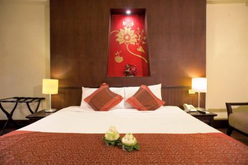 Postel nebo postele na pokoji v ubytování Chiangmai Gate Hotel