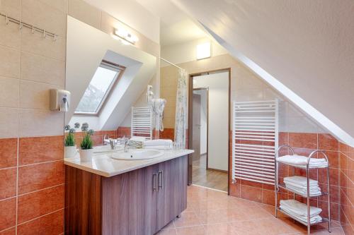 a bathroom with a sink and a staircase at Fortuna 7 Apartments in Hévíz