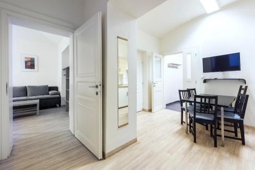 a living room with a table and a dining room at Family Apartments Praha 6 in Prague