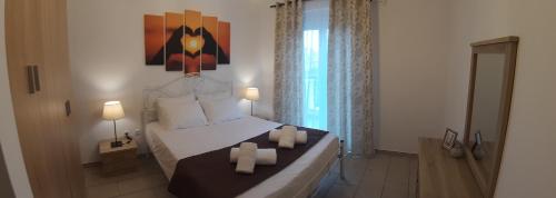 a bedroom with a bed with two candles on it at Skala Pearls A1 in Skala Kefalonias