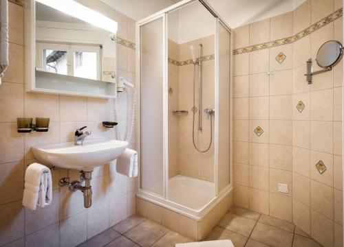 a bathroom with a sink and a shower at Hotel dell'Angelo in Locarno