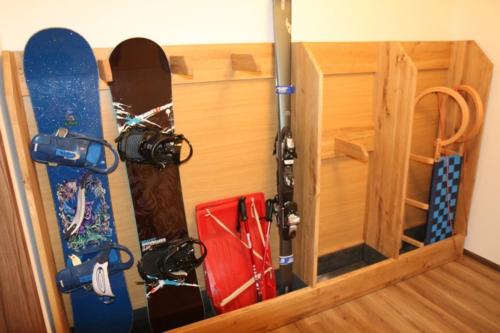 a bunch of snowboards are hanging on a wall at Chalupa Semafor in Dolní Malá Úpa