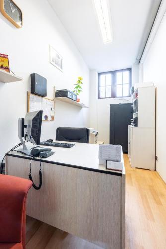 an office with a desk with a computer on it at Family Apartments Praha 6 in Prague