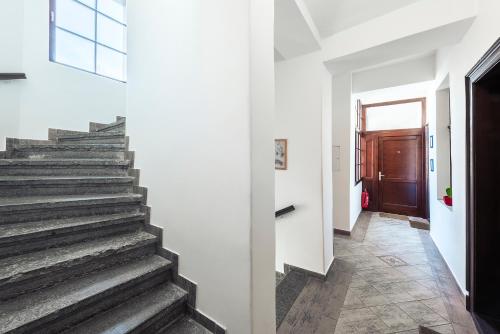 a staircase in a house with white walls at Apartments Praha 6 in Prague