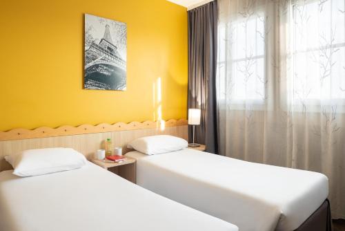 Aparthotel Adagio Val d'Europe près de Disneyland Parisにあるベッド
