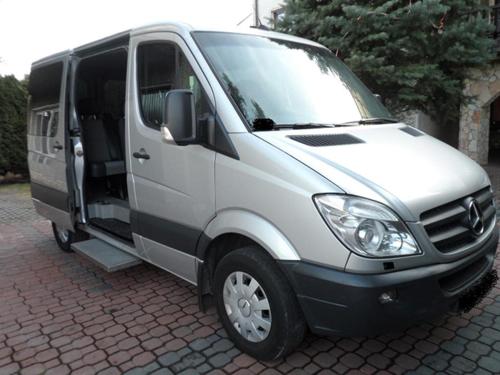 a silver van with its door open on a brick street at Hotelik Gold in Raszyn