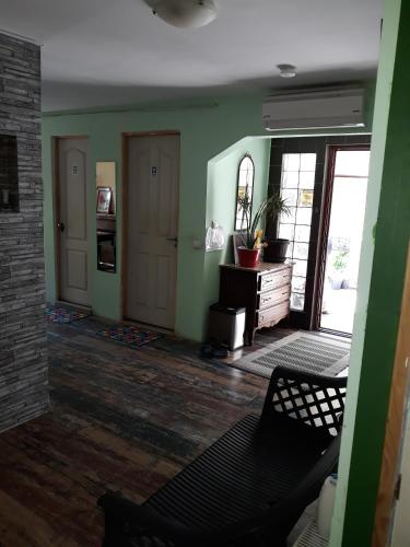 a living room with green walls and a black chair at Old Centrum Bucharest in Bucharest