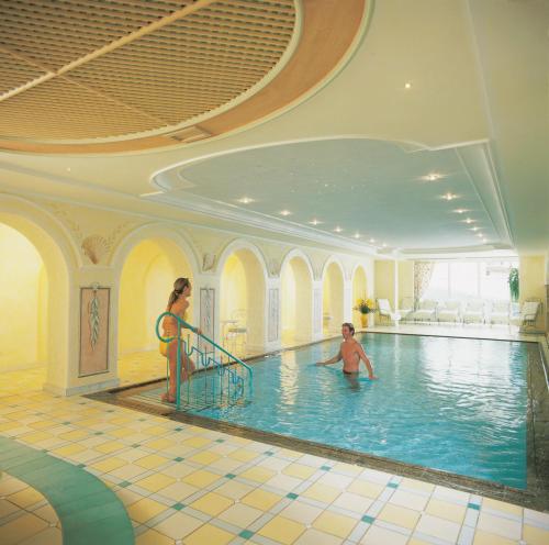 a woman and a child in a swimming pool at Hotel Garni Serfauserhof in Serfaus