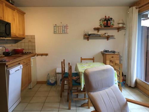 a kitchen with a table and chairs in a kitchen at 40 Edelweiss des neiges in Morillon