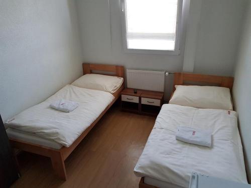 a small room with two beds and a window at Country House Reem in Pommeuse