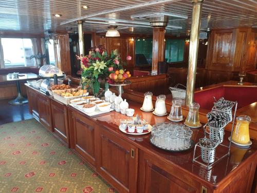 a buffet on a boat with food on it at Kapitein Anna in Amsterdam