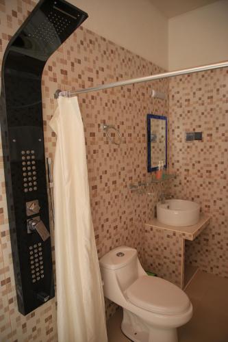 a bathroom with a toilet and a sink at Evila Inn - Thoddoo in Thoddoo