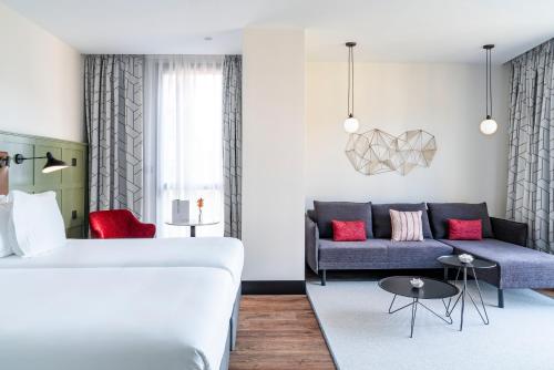 a living room with a bed and a couch at Vincci Consulado de Bilbao in Bilbao