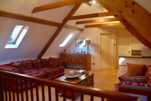 a living room with a couch and a table at The Hideaway-South Downs National Park in Graffham