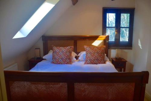 a bedroom with a bed with two pillows on it at The Hideaway-South Downs National Park in Graffham