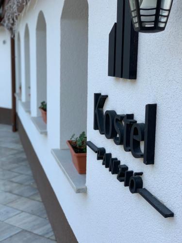 a sign on the side of a building at Kostel Panzió in Kesztölc