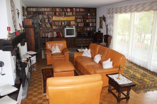a living room with a couch and two chairs at Villa Olevano in Ascona