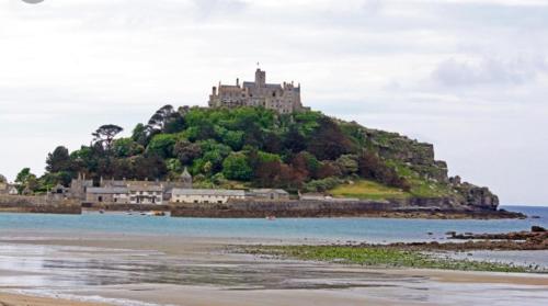 a castle on top of an island in the water at Sammy's place in Hayle