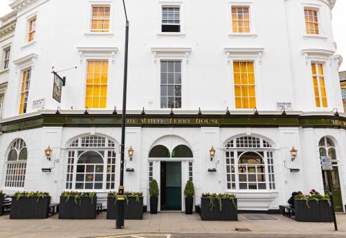 a white building with a sign that reads the white house house at PubLove @ The White Ferry, Victoria in London
