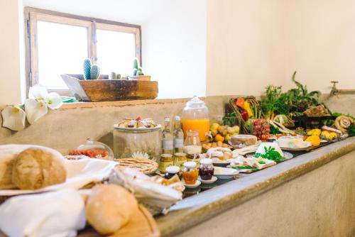 a buffet with a lot of food on a table at Tenuta Santa Trice in Riotorto