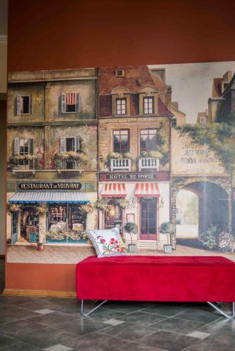 a mural of a building with a red bed in front of it at Province in Cēsis