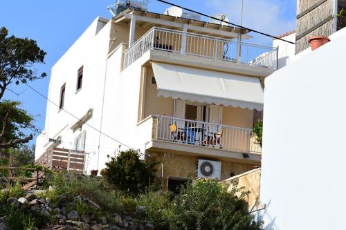 a white apartment building with a balcony at Marinakis Sea View Studios in Sougia