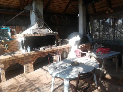 a patio with a fireplace and a table and chairs at Country Rooms near Athens - Airport in Vravrona