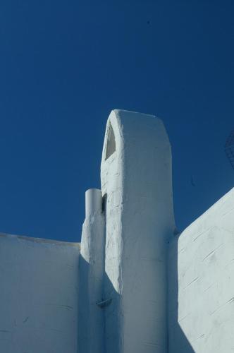 a white building with a window on top of it at Votsalo Apartments in Naousa