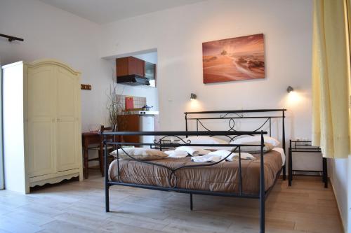 a bedroom with a black bed in a room at Marinakis Sea View Studios in Sougia