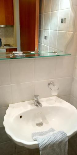 a white sink in a bathroom with a mirror at Gorgones, sea-front, great view in Kardamili