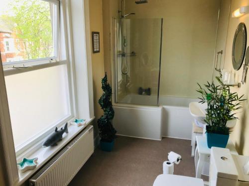 a bathroom with a tub and a sink and a shower at Cornerways Guest House in Carlisle