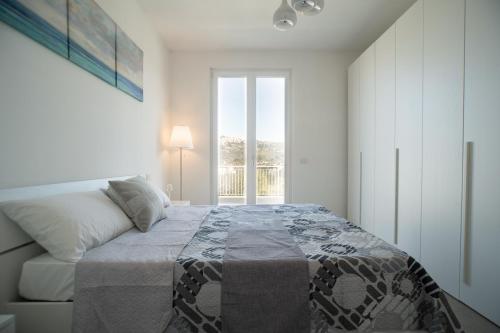 - une chambre avec un lit et une grande fenêtre dans l'établissement Rainone Resort - San Marco di Castellabate, à Castellabate