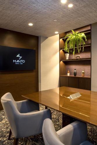 a conference room with a wooden table and chairs at Manto Hotel Lima - MGallery Collection in Lima