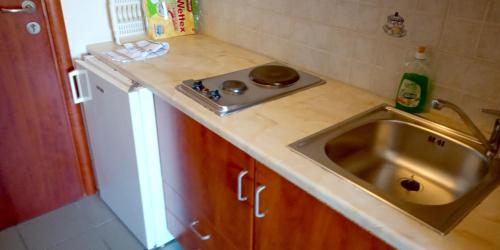 a small kitchen with a sink and a counter top at Gorgones, sea-front, great view in Kardamili