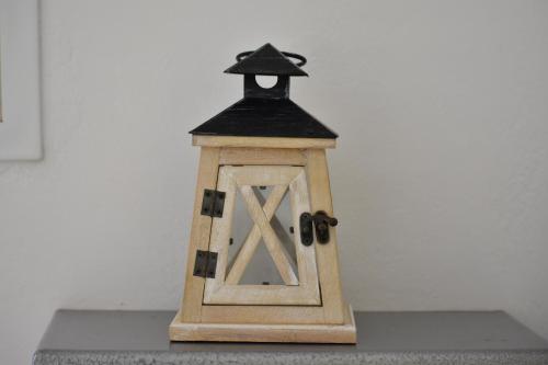 a small wooden lantern sitting on a table at Marinakis Sea View Studios in Sougia