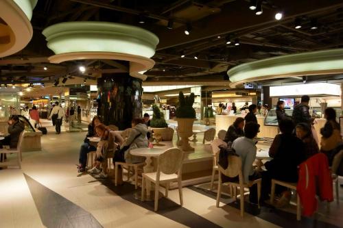 a group of people sitting at tables in a mall at Master Hotel in Taipei