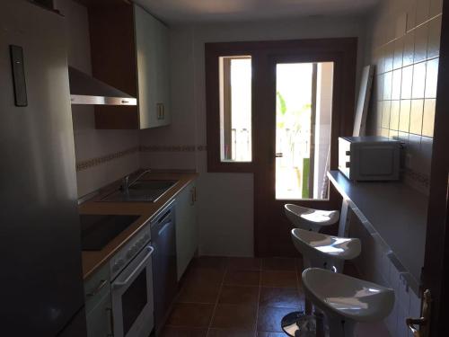 a kitchen with two toilets and a sink and a window at Costa Esuri Golf y Playa in Ayamonte