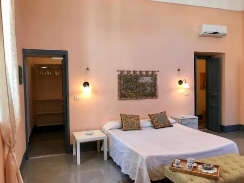 a bedroom with a bed and a table and a couch at Town View in Noto