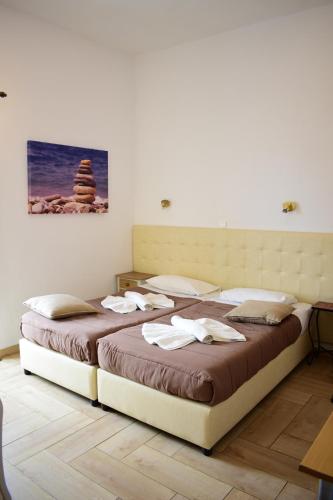 a bedroom with two beds with towels on them at Marinakis Sea View Studios in Sougia