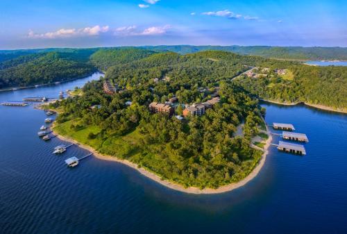 an island in the water with houses and boats at Still Waters Resort in Branson