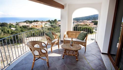 a balcony with chairs and a table and a view at Impressions in Cala Gonone