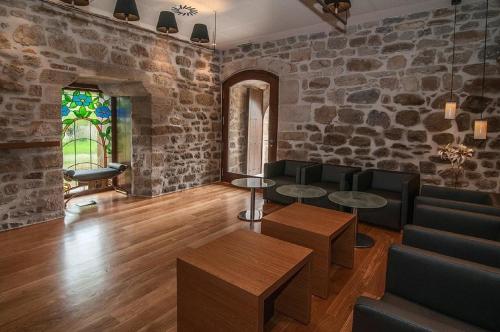 a living room filled with furniture and a fireplace at Hotel Torre Zumeltzegi in Oñati