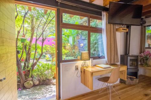 a room with a desk and a large window at Mesón De Leyendas Breakfast & Downtown in Valle de Bravo