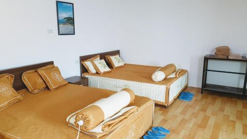a room with two beds and a table at B Stay Hotel in Phu Quoc