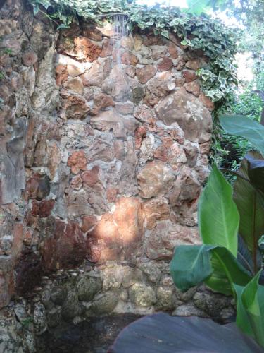 an old stone wall with a water fountain at Relax tiny villas 40 meters of the beach in Korčula