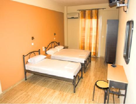 a hospital room with two beds and a television at Villa Eleni in Paralia Katerinis