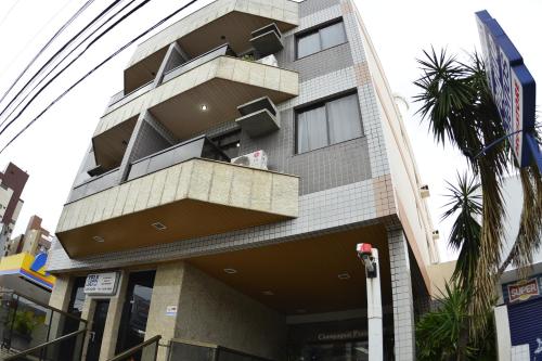a building with balconies on the side of it at Champagnat Praia Hotel in Vila Velha