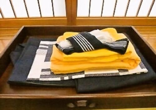 a pile of towels sitting on top of a table at Wakaba Ryokan / Vacation STAY 29460 in Sakata